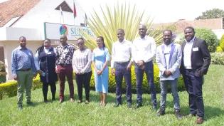 A group fo people standing on grass