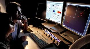 Two students analyse microscopy data