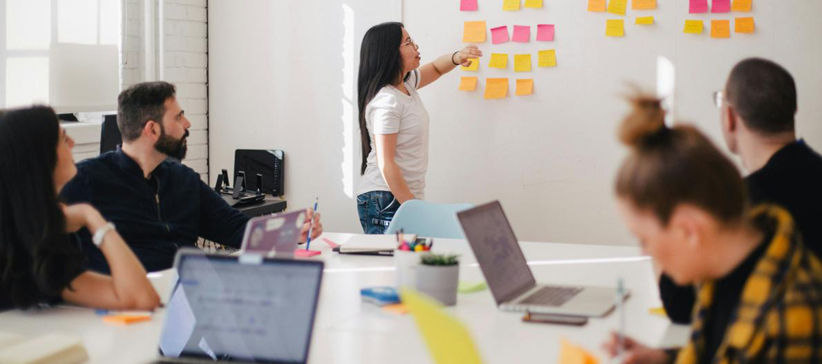 Group around a table with a whiteboard